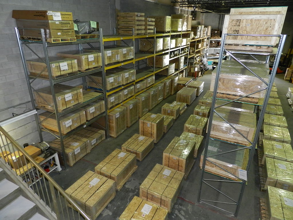 Warehouse shelving aisles with boxed locomotive components